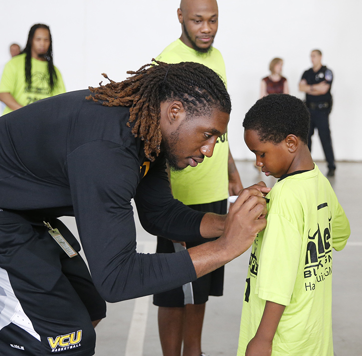 Mo Alie-Cox signs his #12 on a shirt.