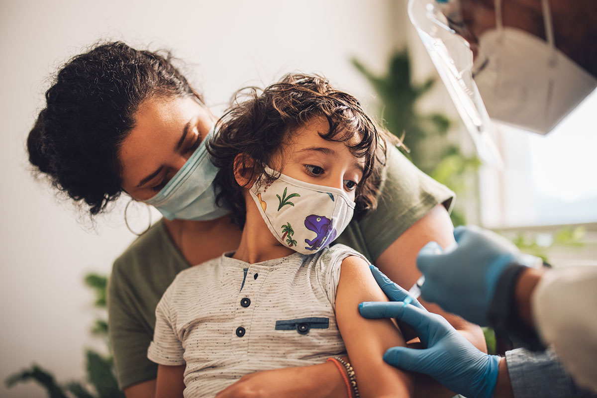 A young child receives a vaccine shot.