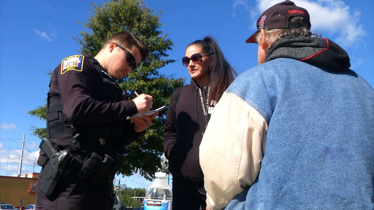 Officer Travis Adams and Peer Recovery Specialist Joy Bogese helping a homeless veteran. Credit: Rolynn Wilson for WRIC 8 News.