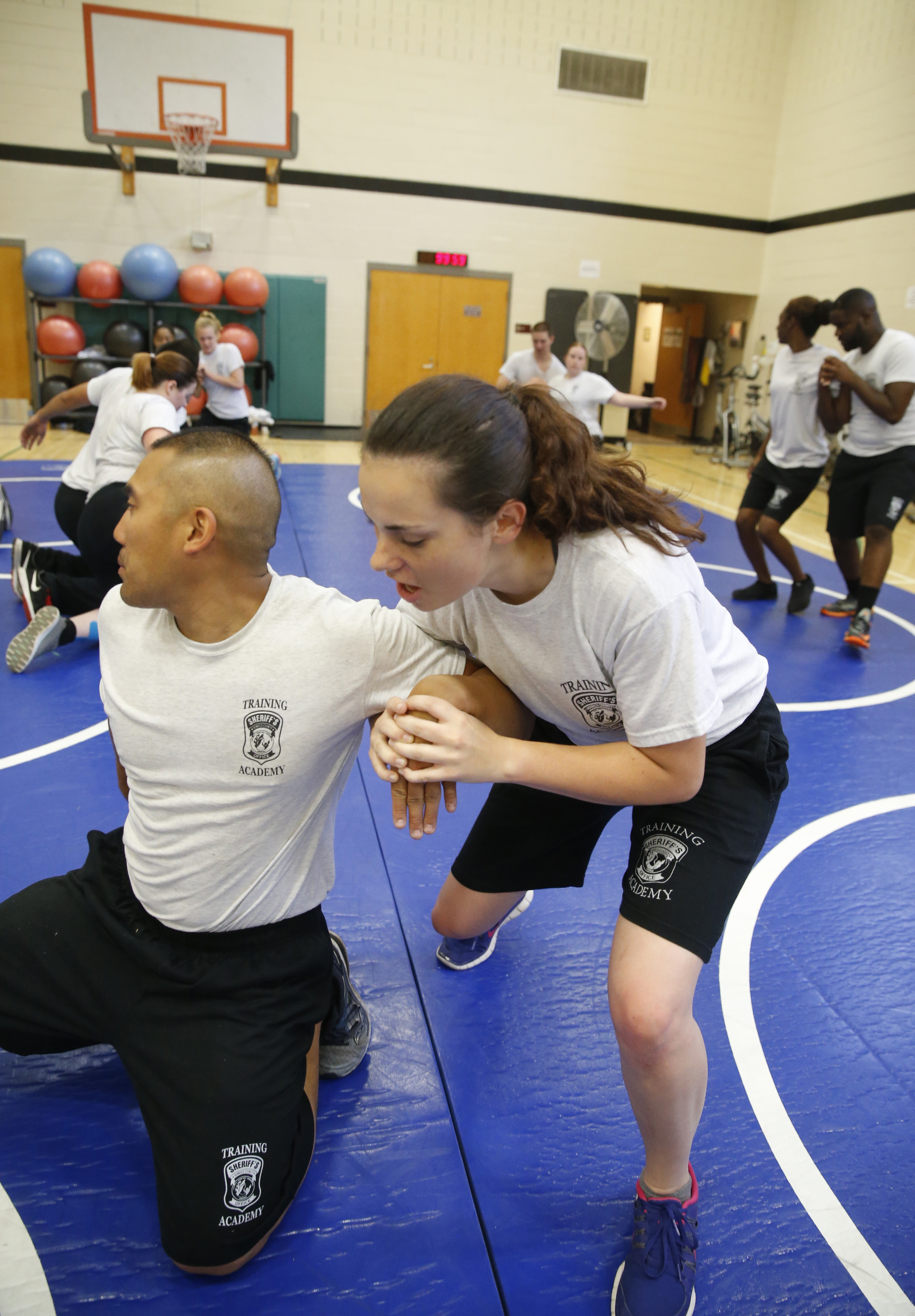 Academy recruit Taylor Lisco demonstrates how to correctly apply pressure to a wrist on a fellow recruit in order to takedown an offender during a defensive tactics course on July 13 at the Henrico County Training Center. 