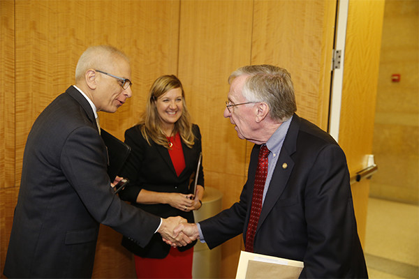 Wilder School Dean John Accordino and Robyn McDougle greet Del. Kenneth Plum of Reston.