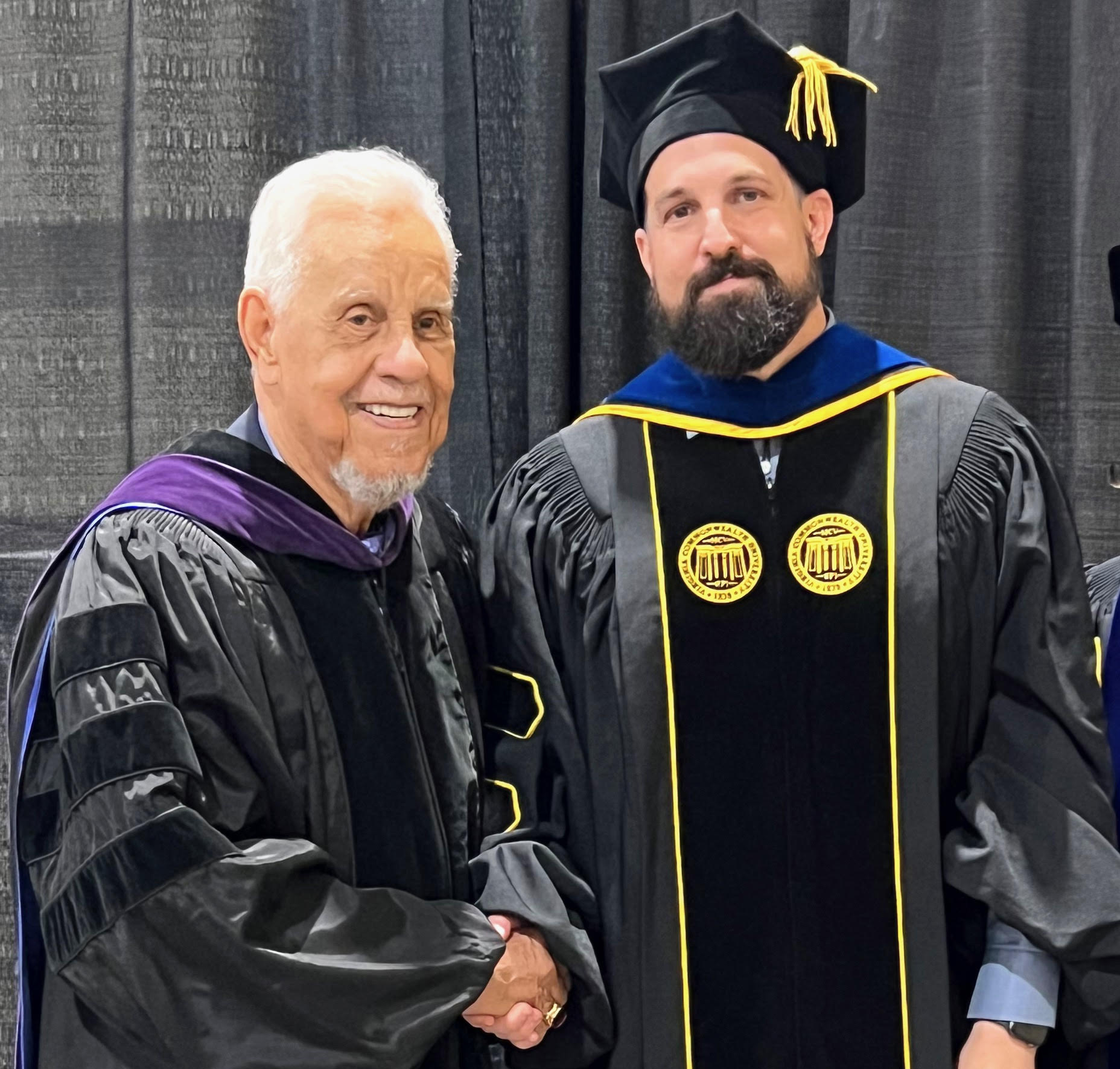 Brad Lehmann poses with Gov. L. Douglas Wilder during commencement.